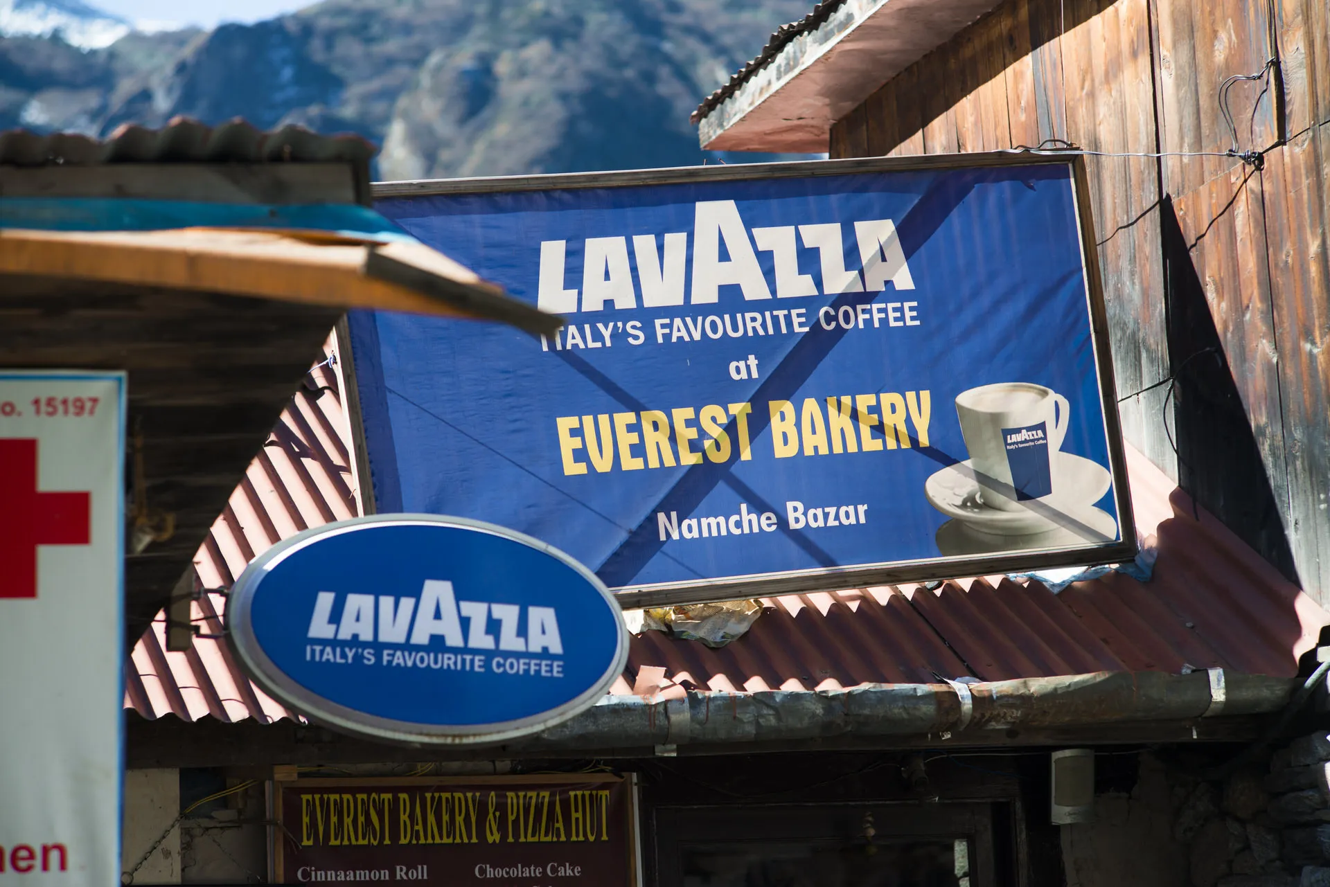 A vinyl banner above a Sherpa shop in Namche Bazaar advertises Lavazza coffee at the Everest Bakery.