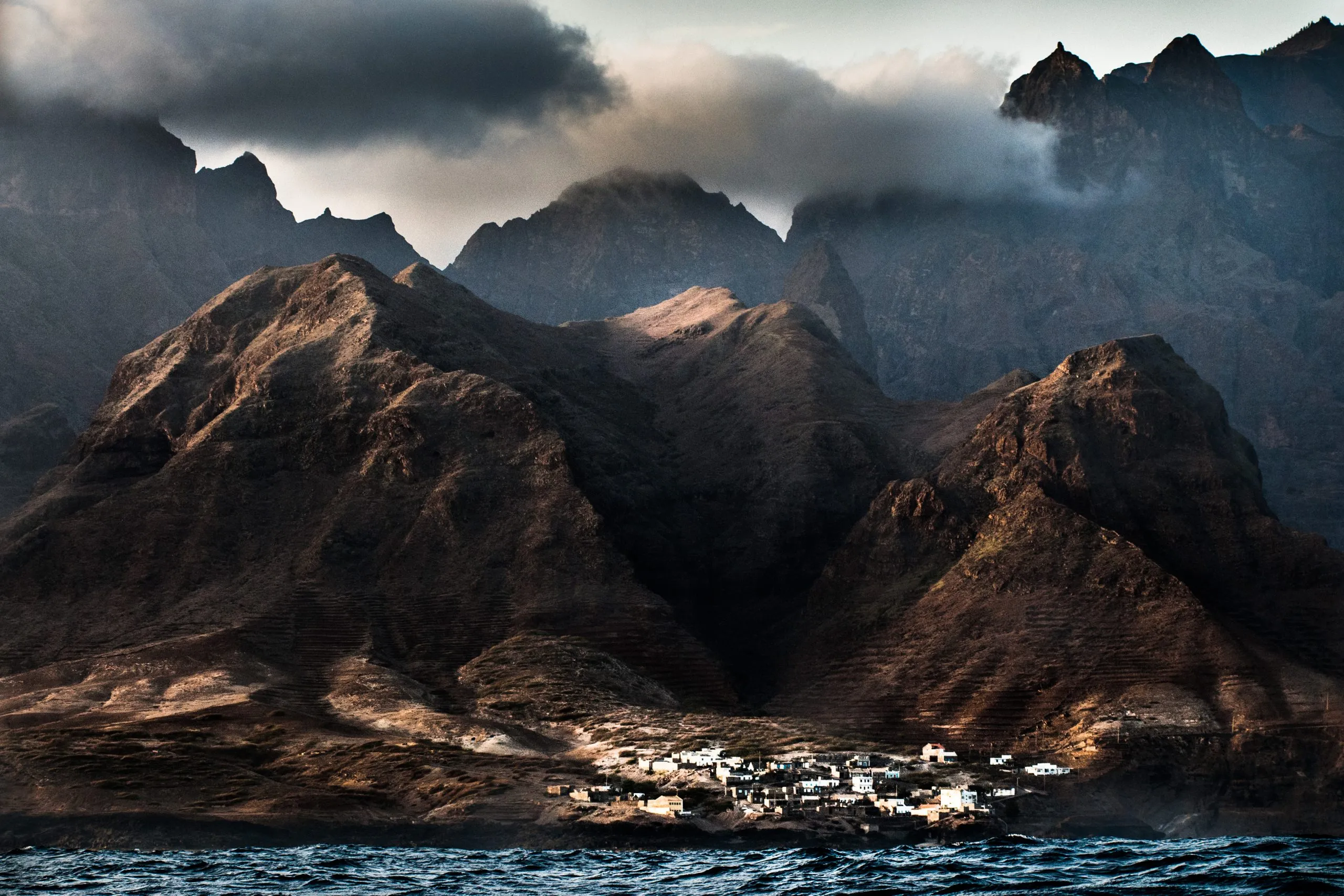 A village set against the volcanic cliff faces of Santo Antão, Cape Verde.