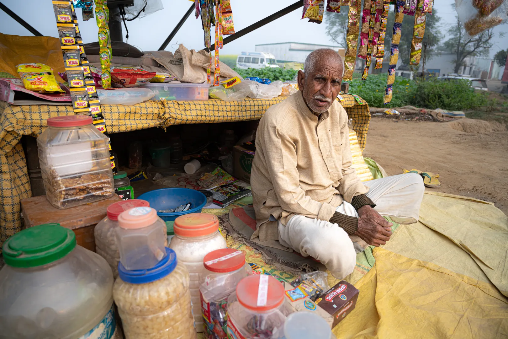 Om Prakash sells foods, crisps and sweets — all packaged in tiny packets of plastic.