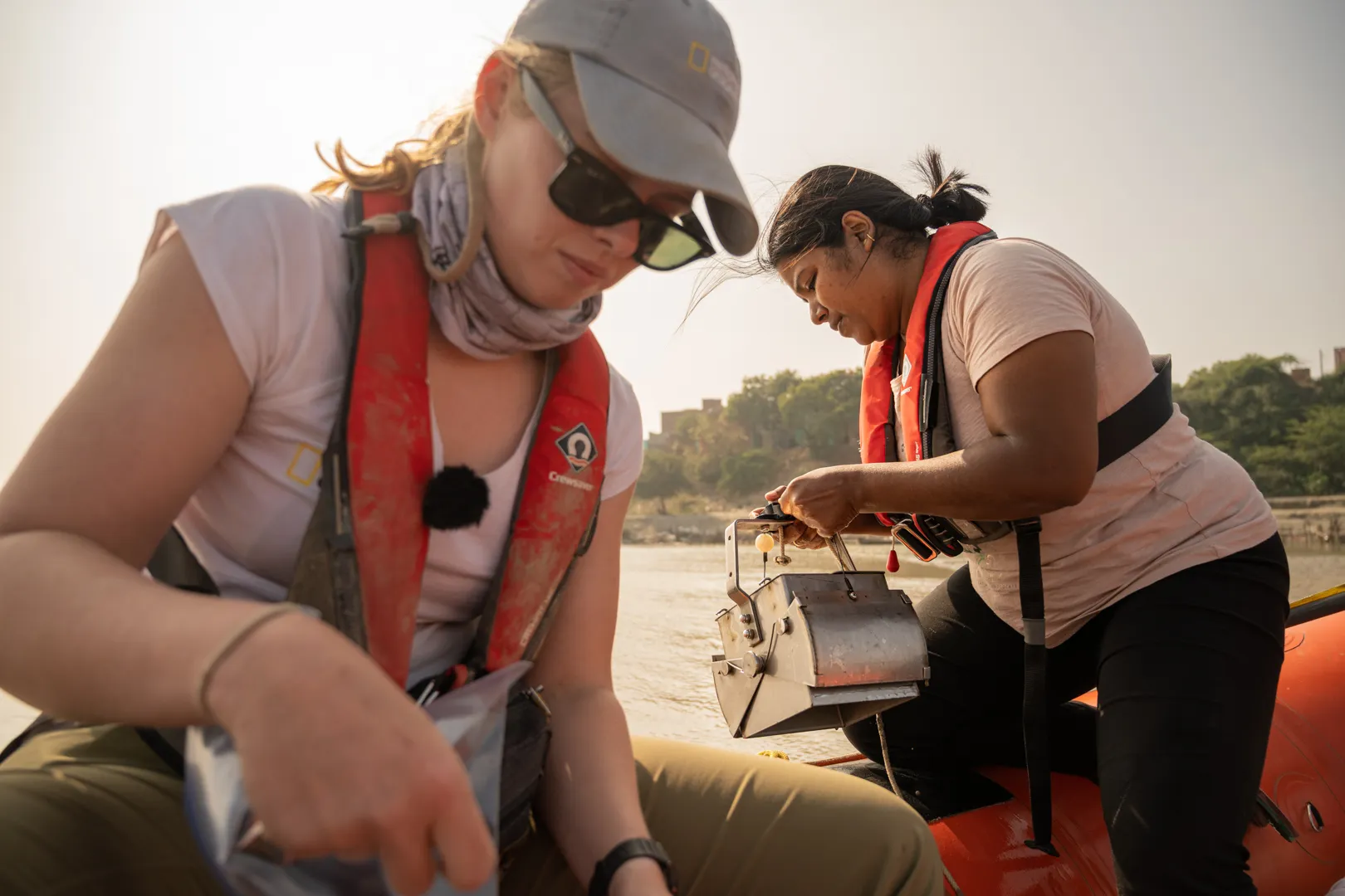 Scientists Imogen Napper and Sunanda Bhola getting silt samples from the bottom of the Ganges riverbed.