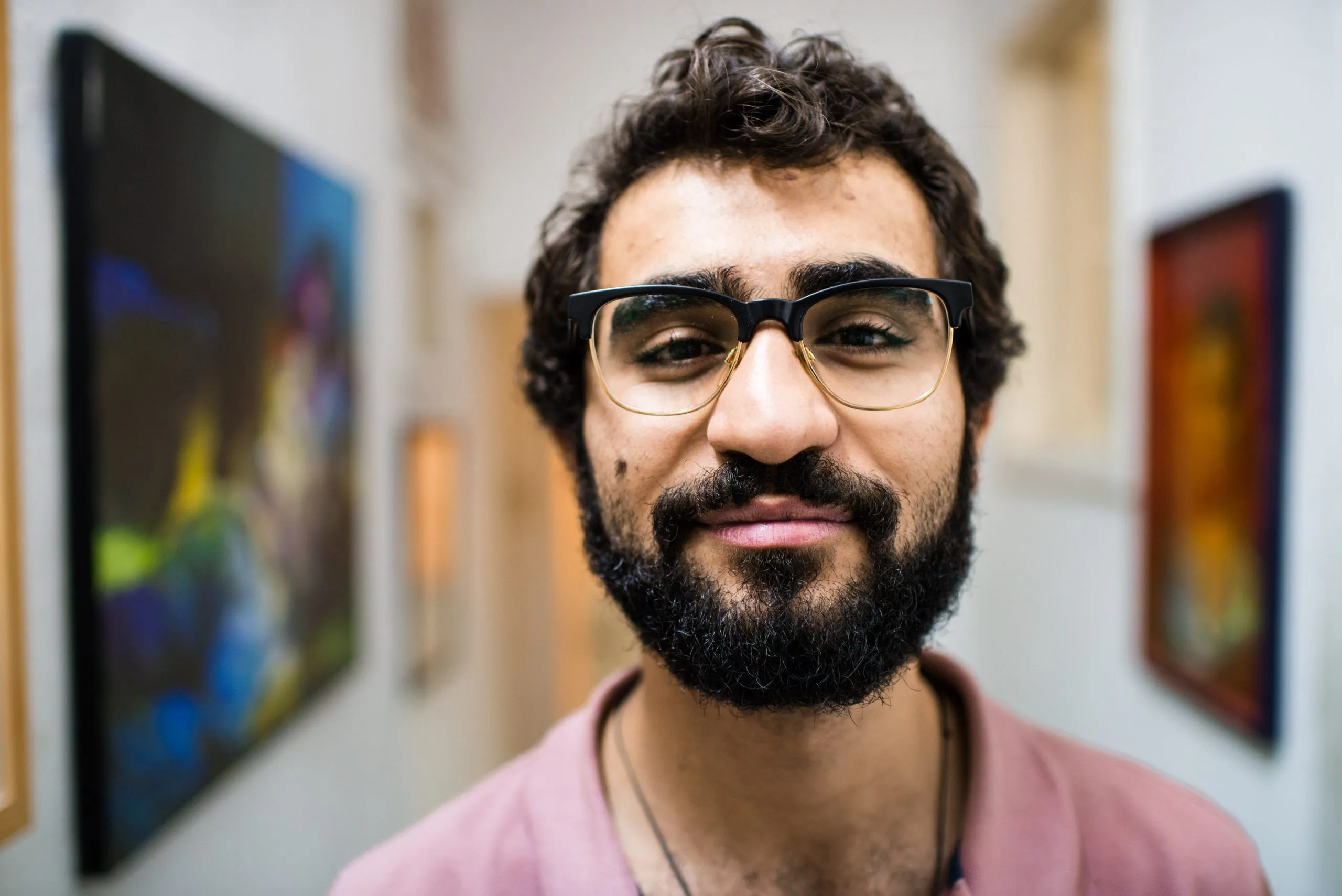 Close portrait of a young bearded artist with glasses, in his art studio in Amman, Jordan.
