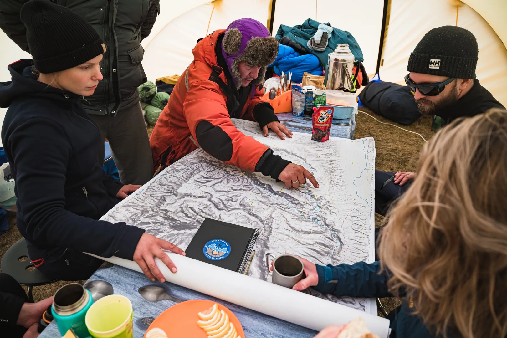 Dr. Katja Adolphson, Dr. Alexey Dudashvili and Mats Kahlström inspect a map of the project locations during the expedition.