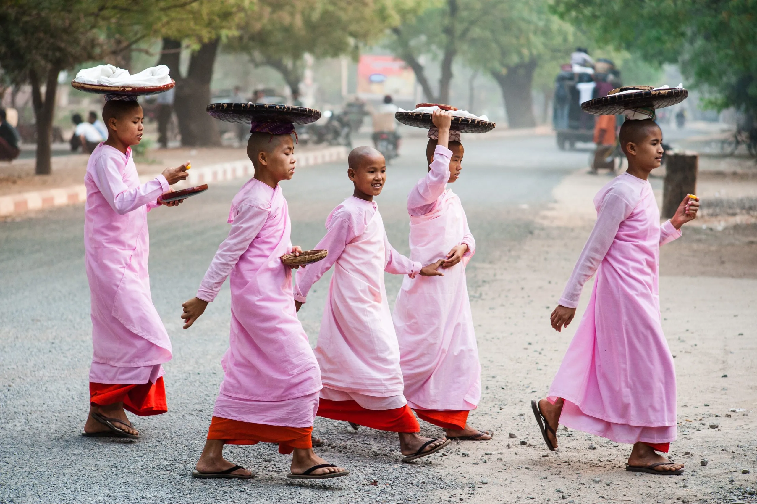 Buddhist nuns walking on early morning pindapata food collection in Bagan, Burma.