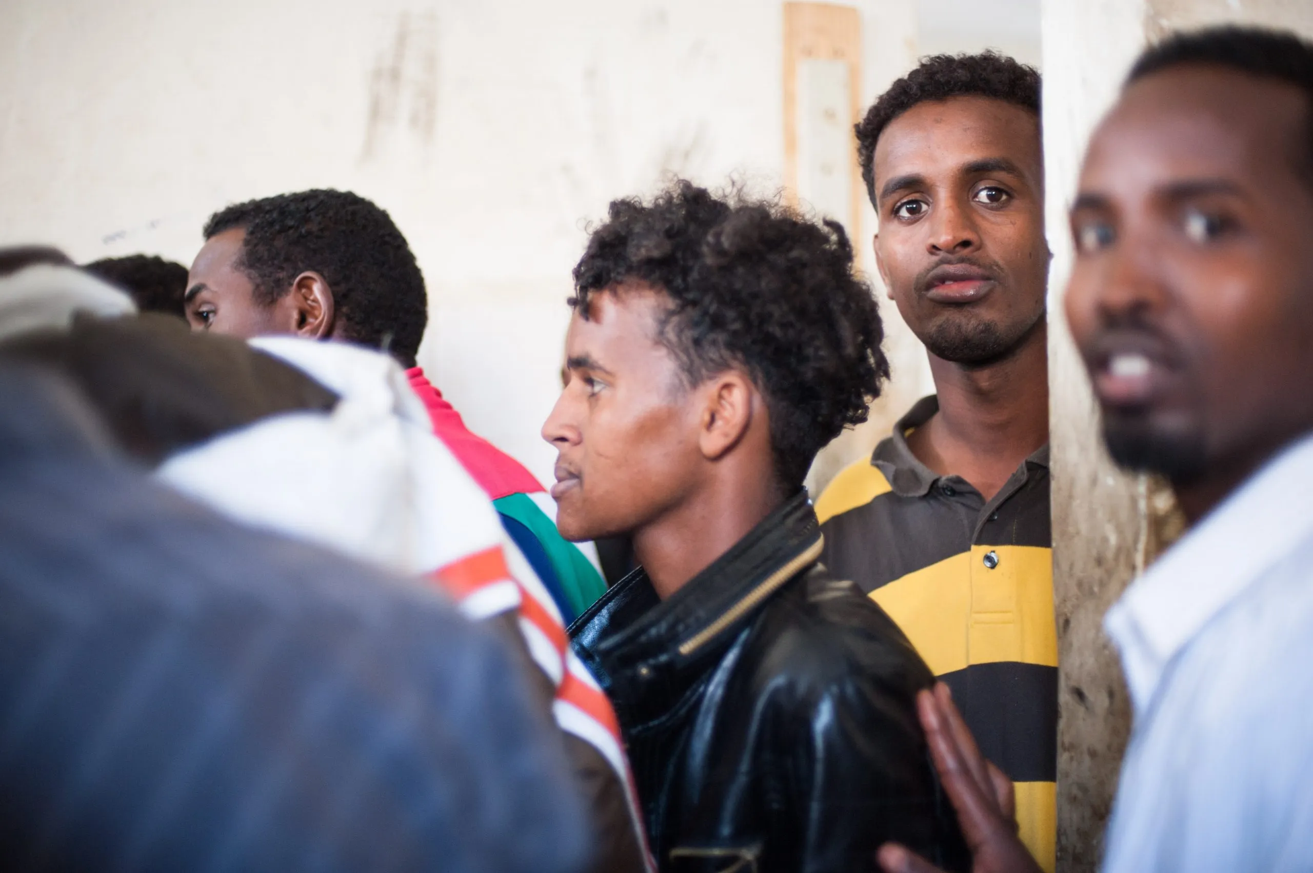 A close-quarters shot of several young men gathered together inside the housing compound on Malta.