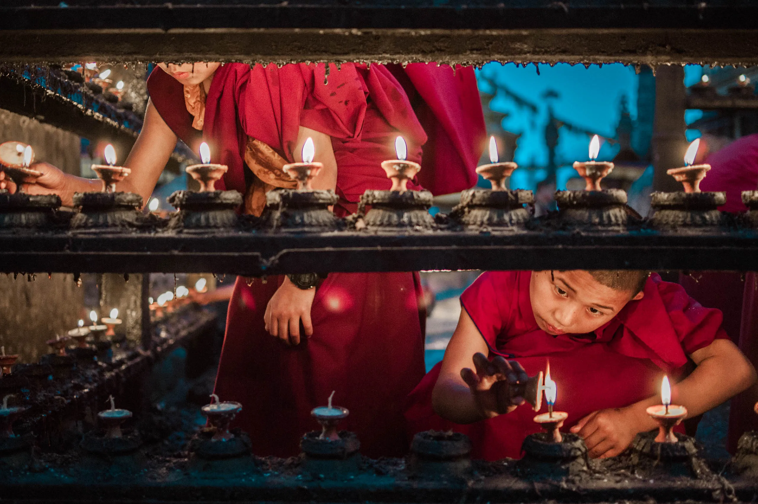 Monks light thousands of candles at the Swayambhunath temple above Kathmandu, Nepal.