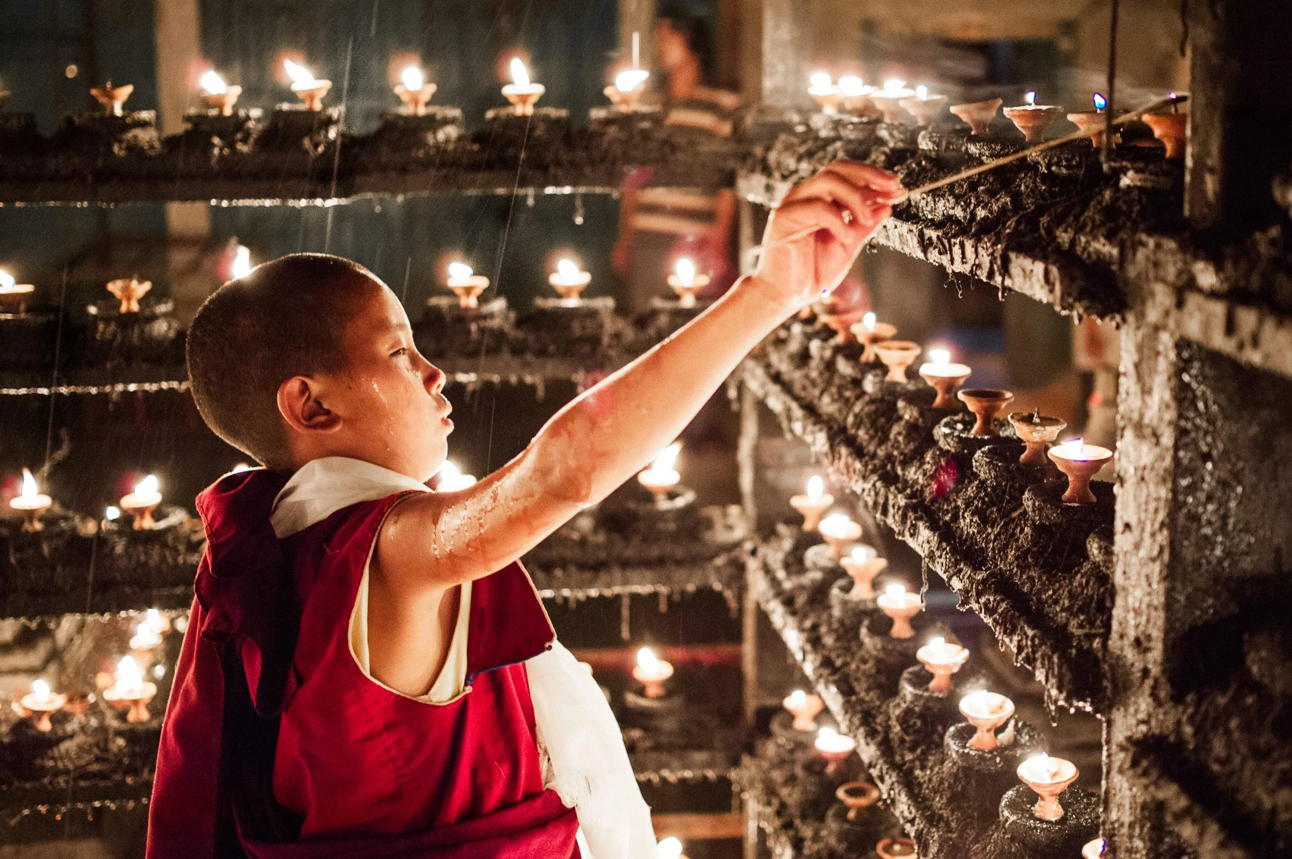 A young monk at Swayambhunath temple, Nepal, preparing for the Gyalwa Karmapa birthday celebrations.
