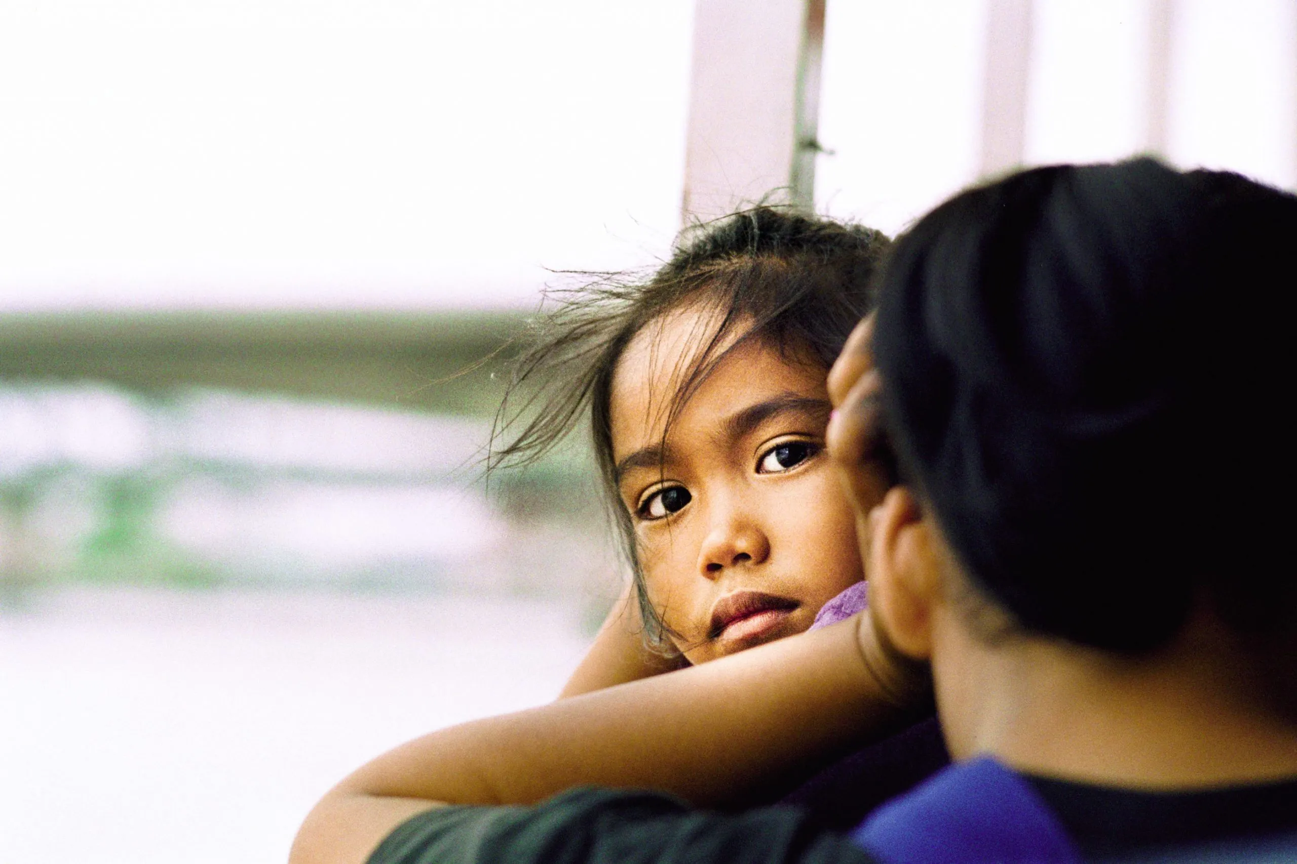 A girl crossing the Chao Phraya river in Bangkok with her mother.